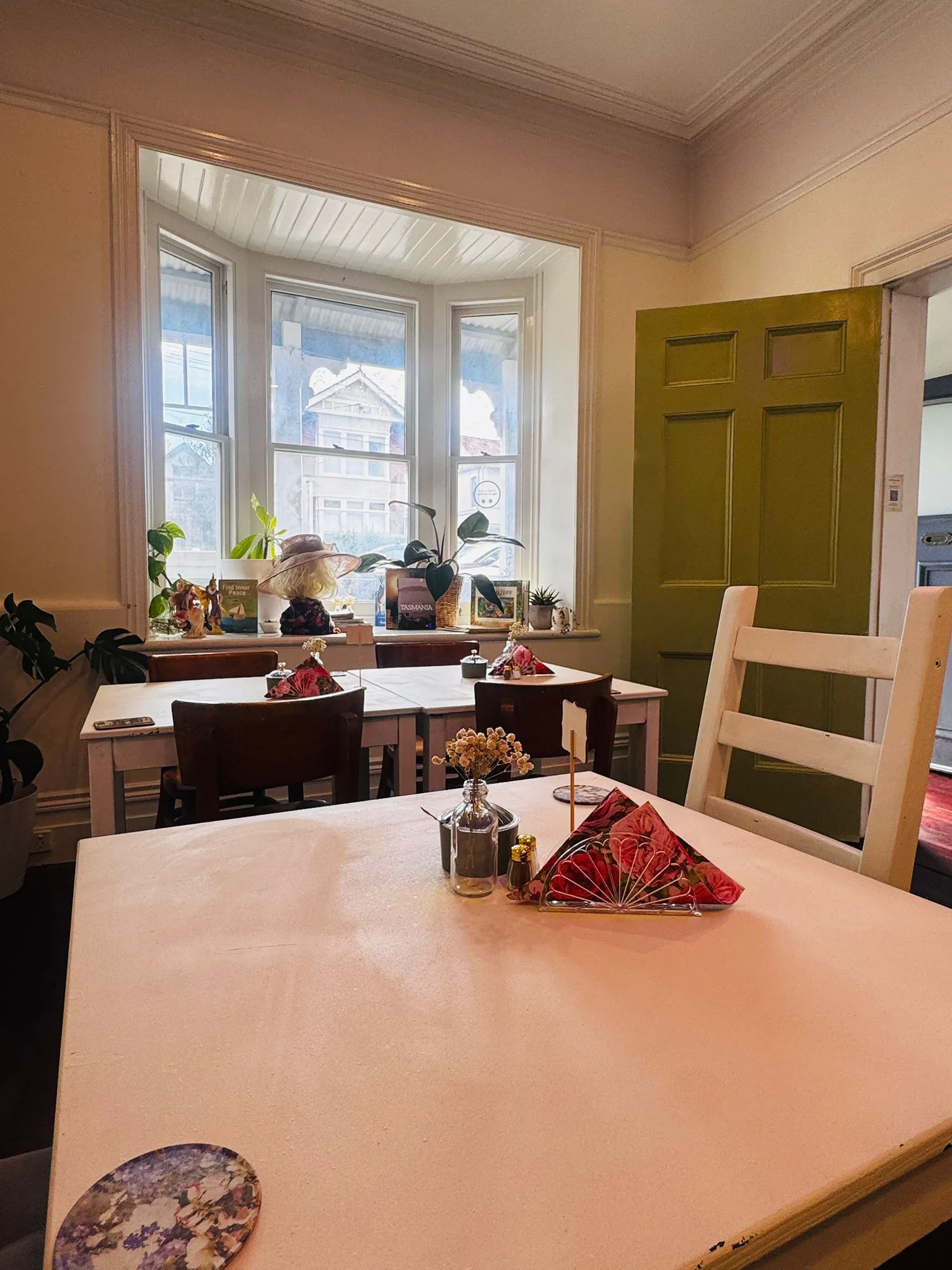 Warm dining room and green door at Save For A Date Café