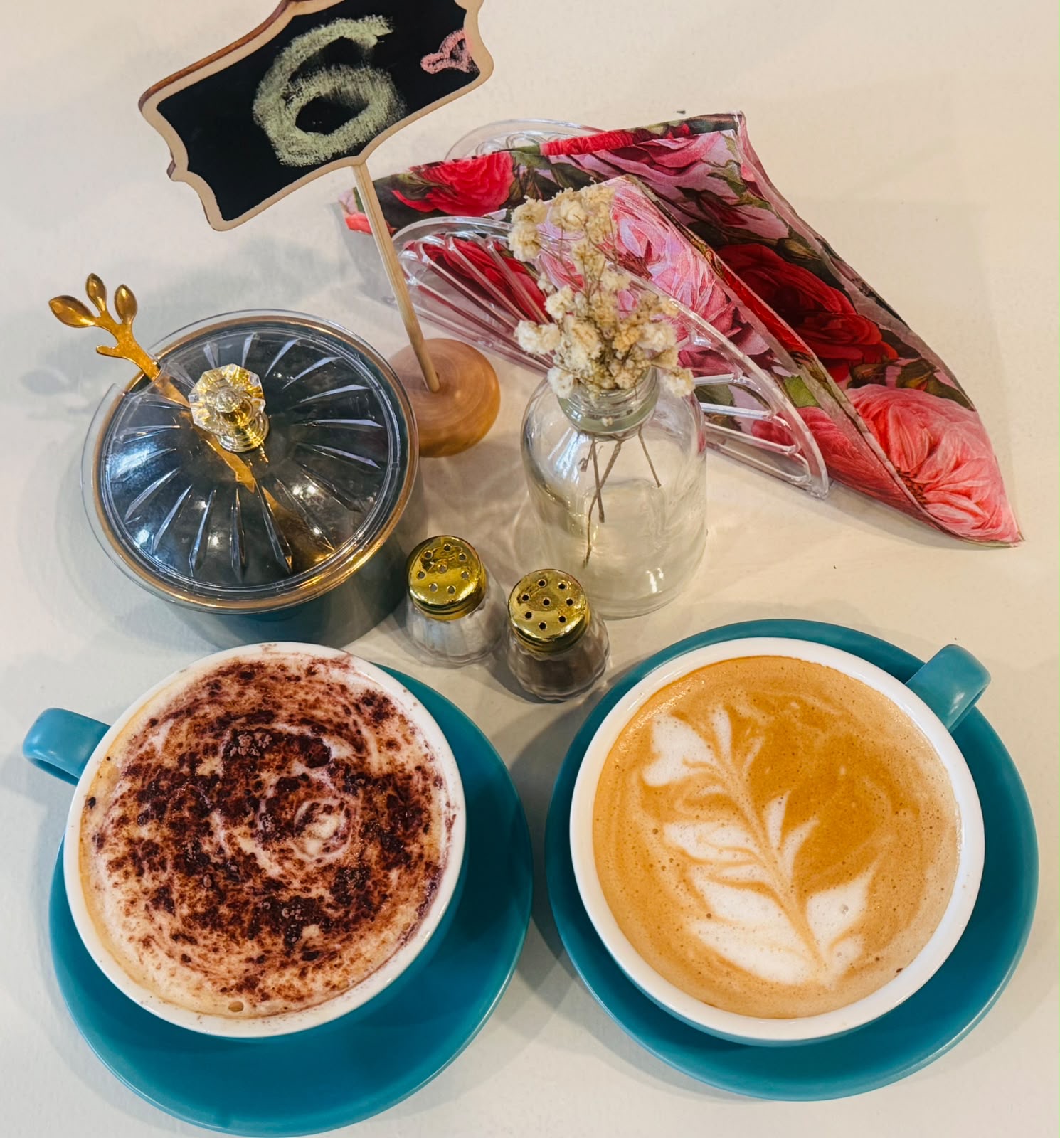 Two coffees served in turquoise cups