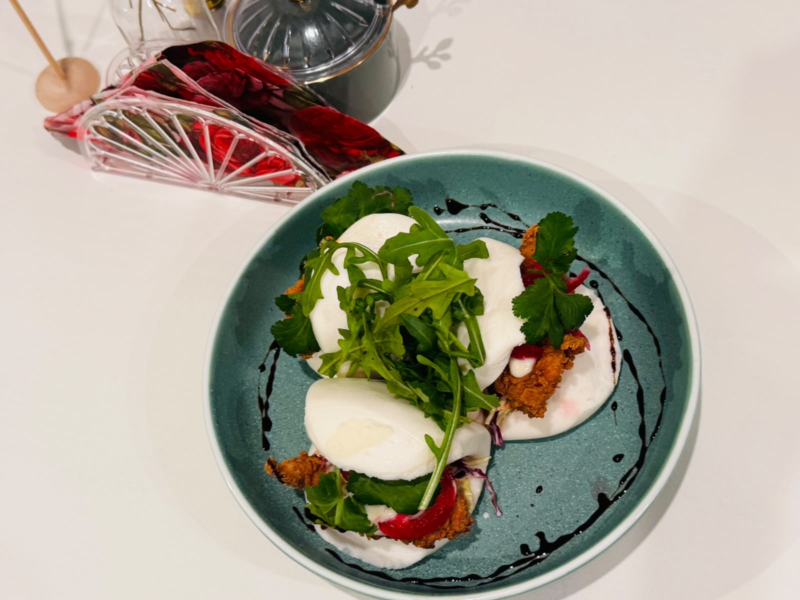 Crispy chicken bao with fresh greens and creamy sauce